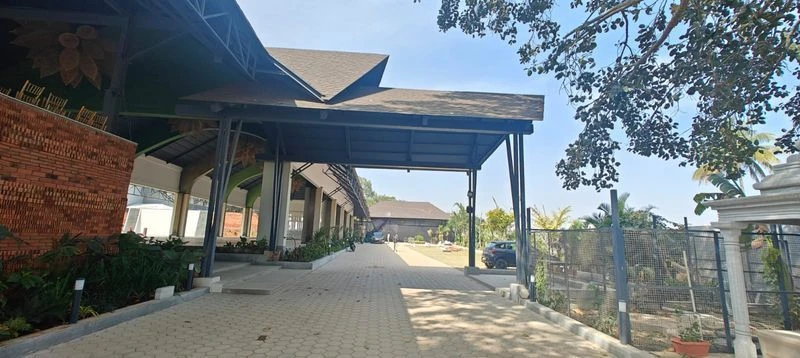 Existing ReZa roofing reference showing a shingle-covered hospitality building and sheltered walkway