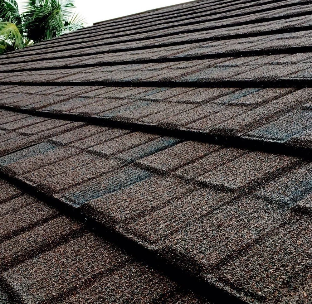 Close-up of the granular surface and layered shingle-style stone-coated metal roof tiles