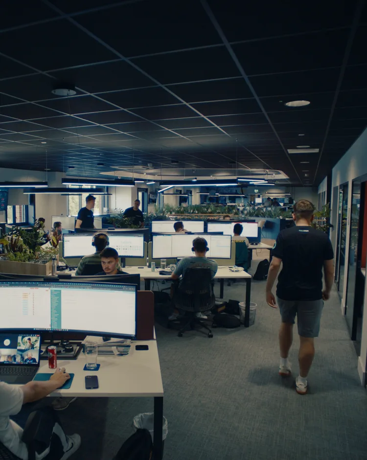 The Halo office in Stowmarket, with team members working at desks and one walking through the room