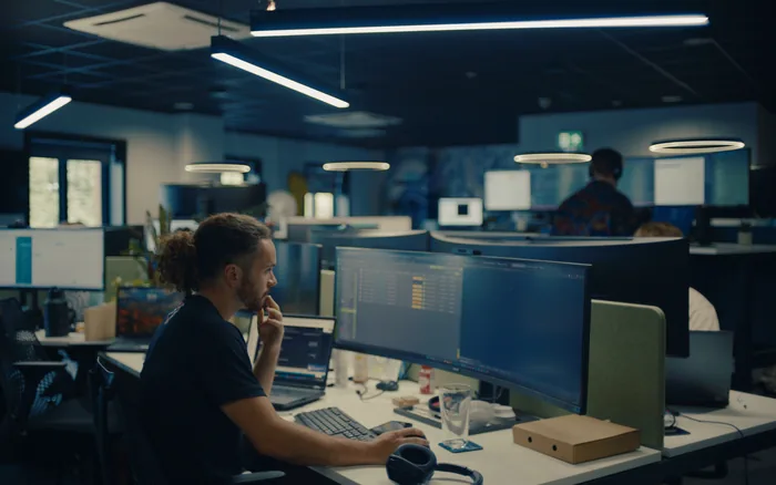 A Halo developer working at a desk in the open plan Stowmarket office