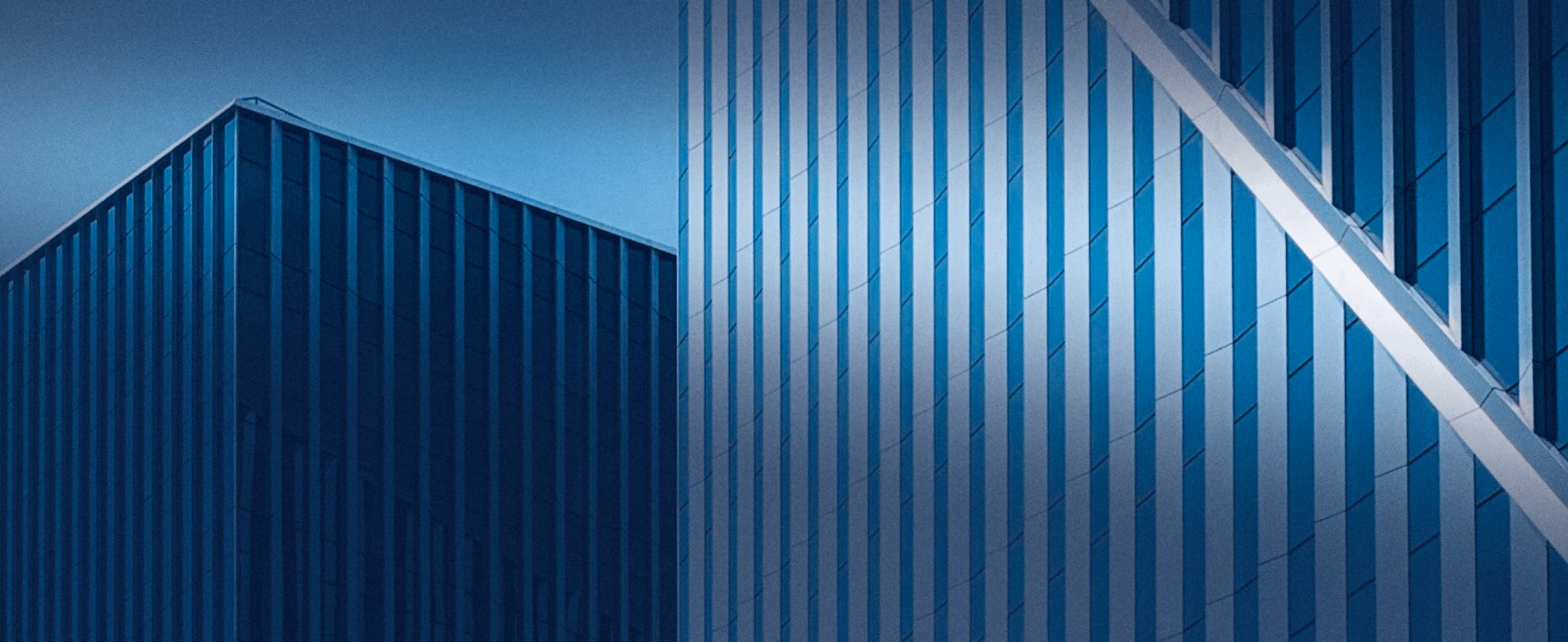 Modern blue building facade with vertical geometric panels.