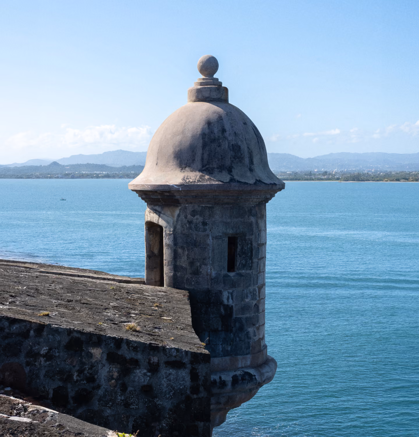 Historic stone watchtower overlooking the blue sea.