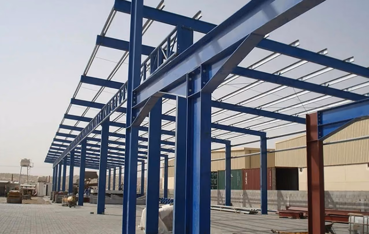 Blue steel frame structure of a warehouse under construction.