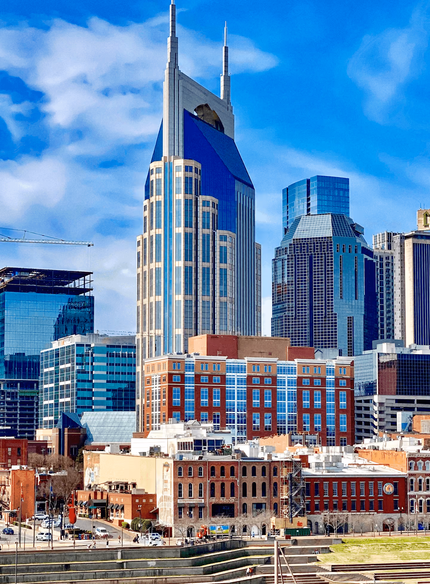 City skyline featuring a tall skyscraper with twin spires among surrounding downtown buildings.