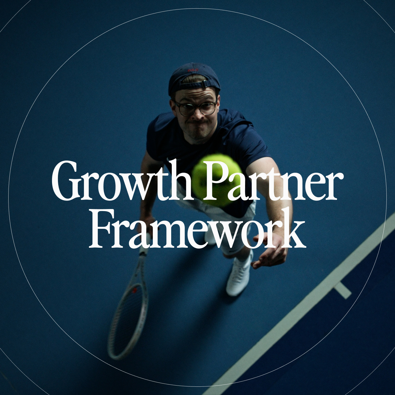 Man in glasses and cap reaching forward to hit a tennis ball on an indoor court.