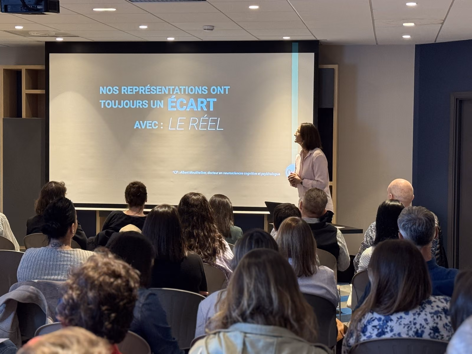 Une intervenante ODBI s'adresse à une salle pleine pendant une conférence