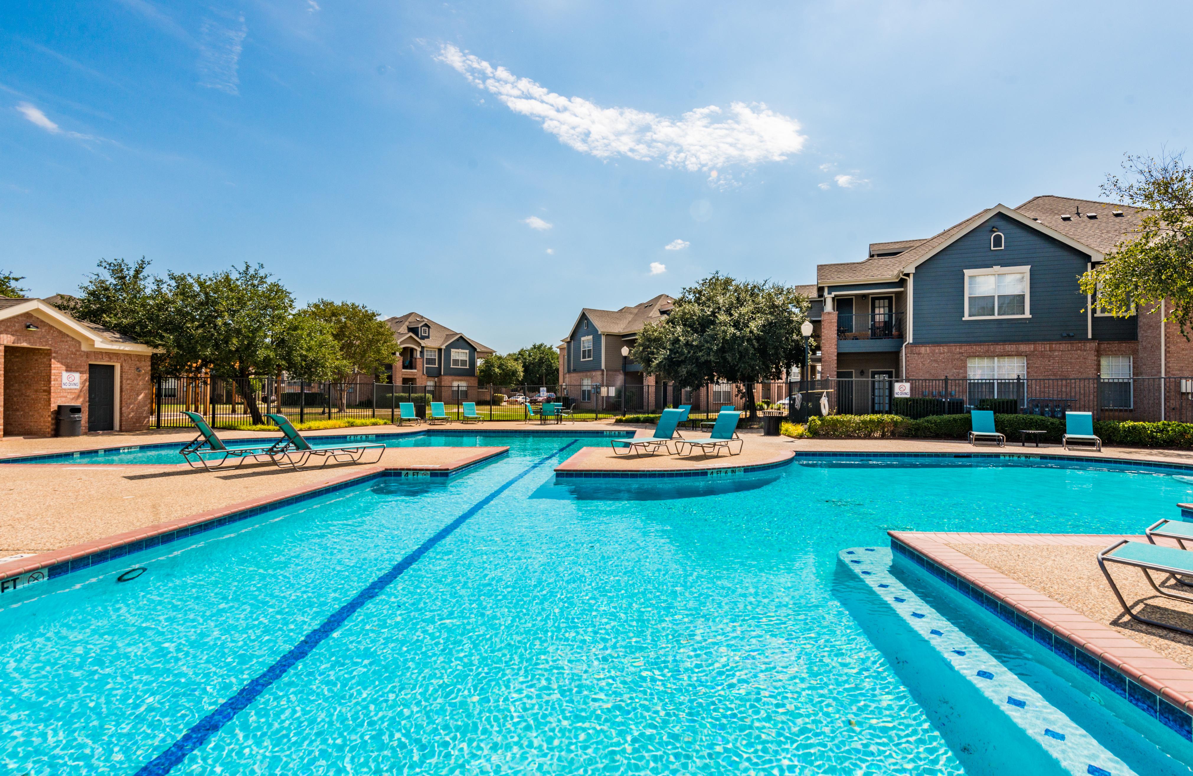 Swimming pool featuring lap lane and poolside lounge seating