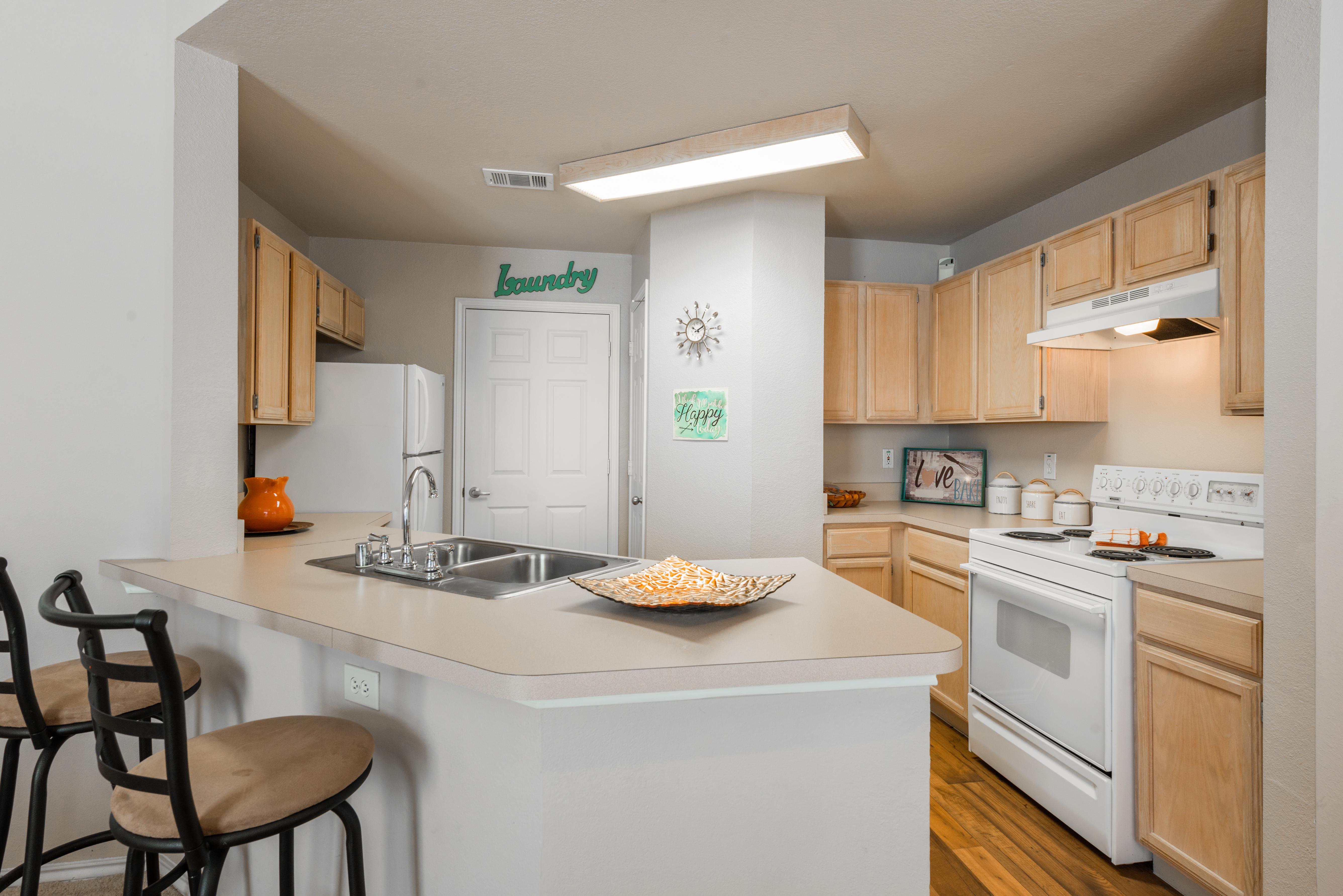 Kitchen with attached peninsula counter and barstool seating