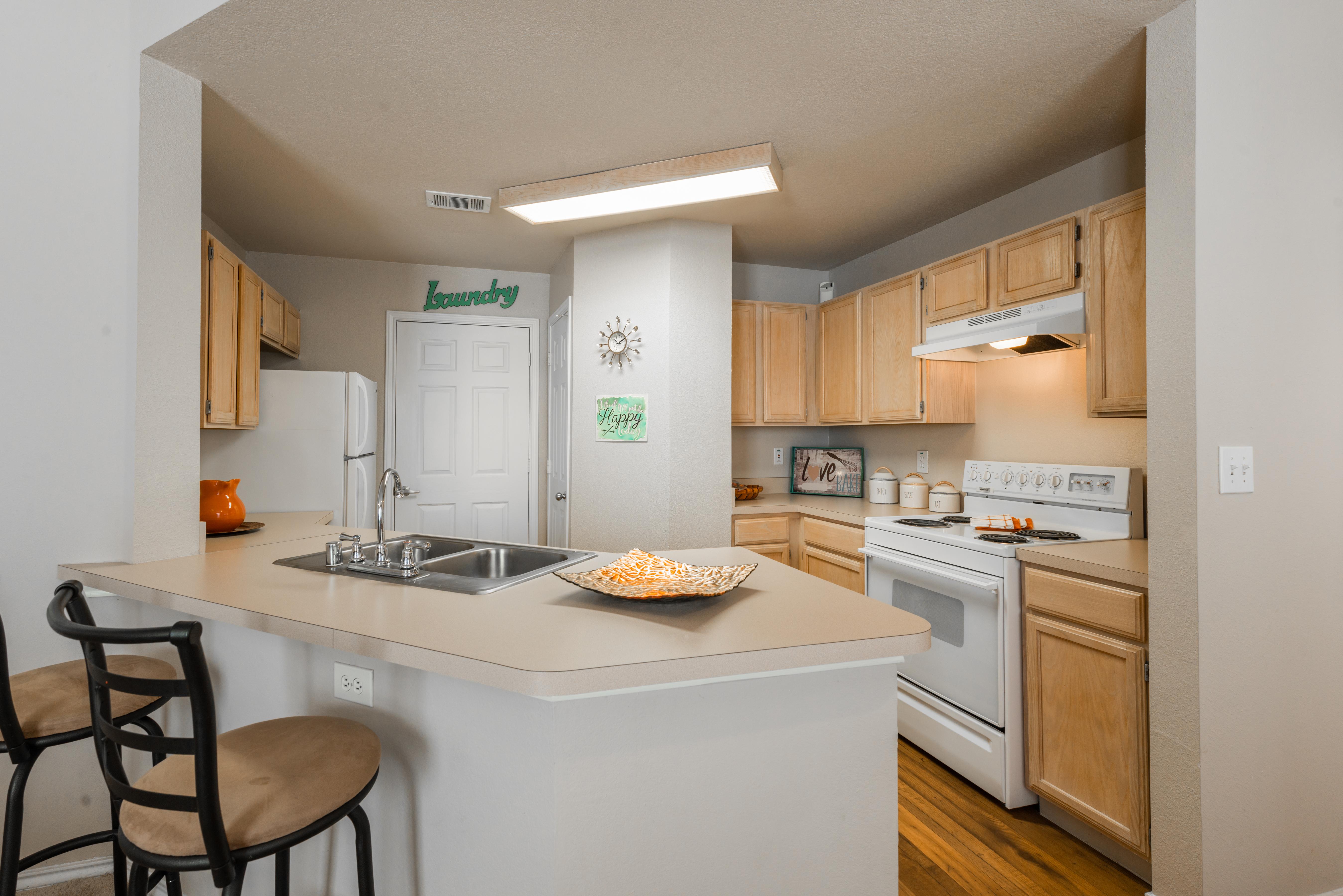Kitchen with attached peninsula counter and barstool seating