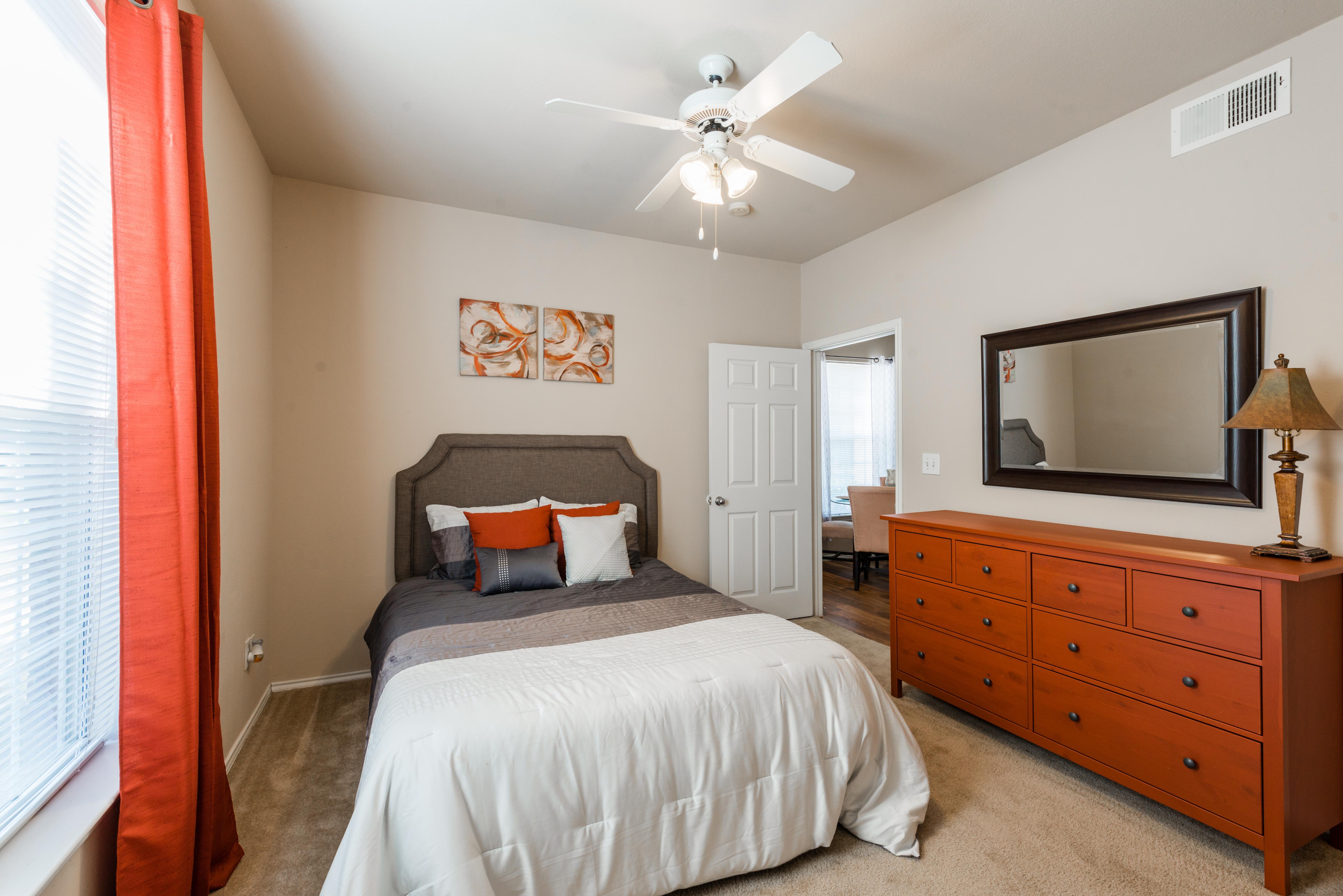 Furnished bedroom with ceiling fan