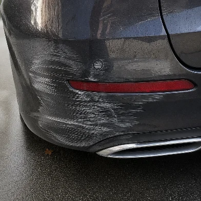 Submitted photo: car bumper, damage edited to look severe