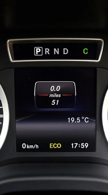 Phone filming a dashboard warning light, guided step on screen