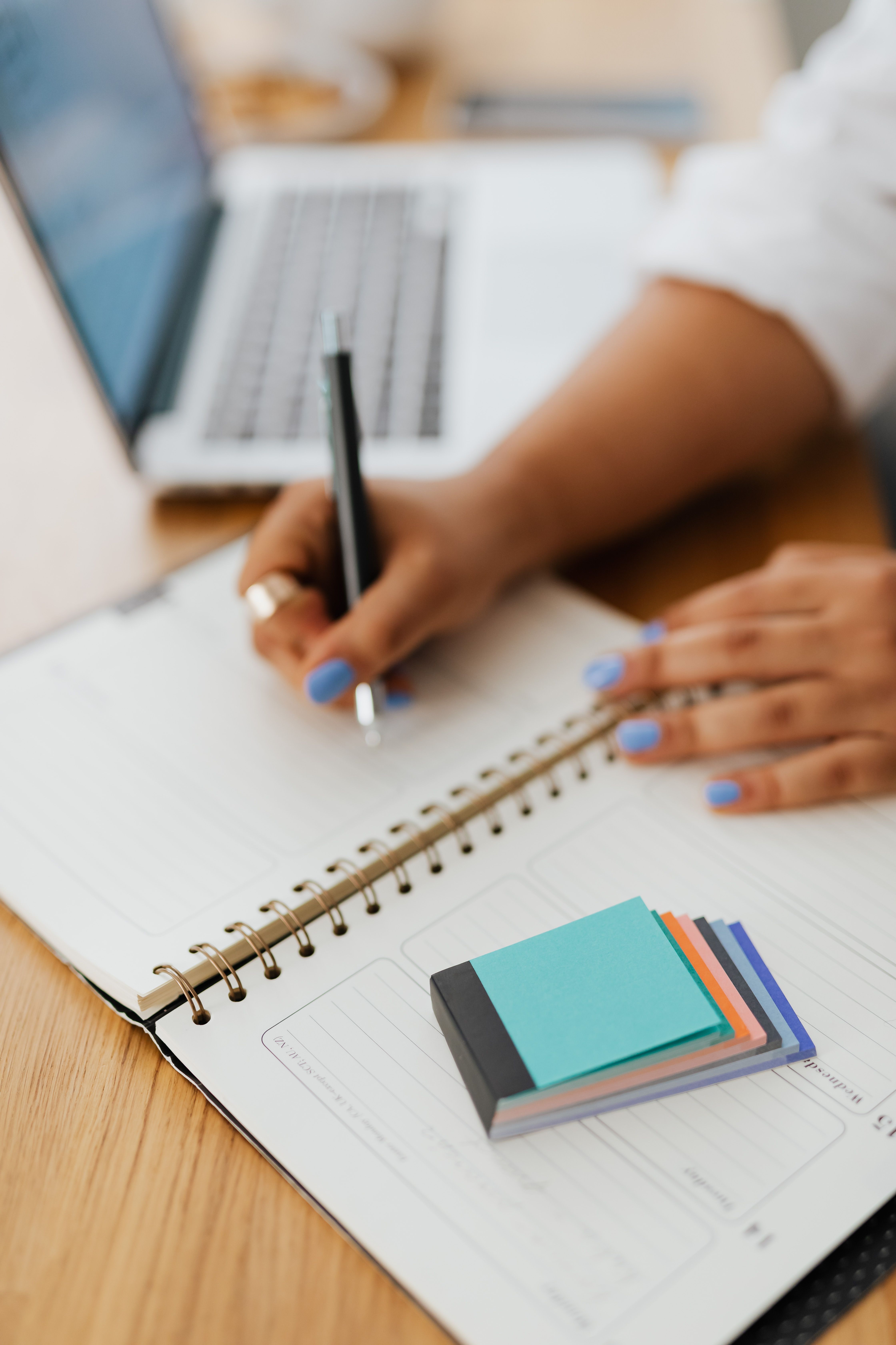 Ladies' Night Out photo. A woman is writing in a planner with sticky notes.