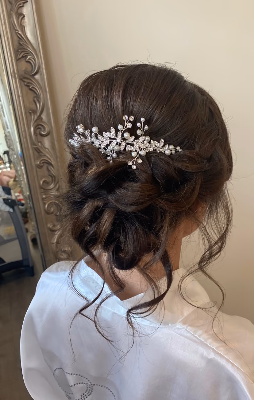 Back view of a textured low bun finished with a pearl hair comb