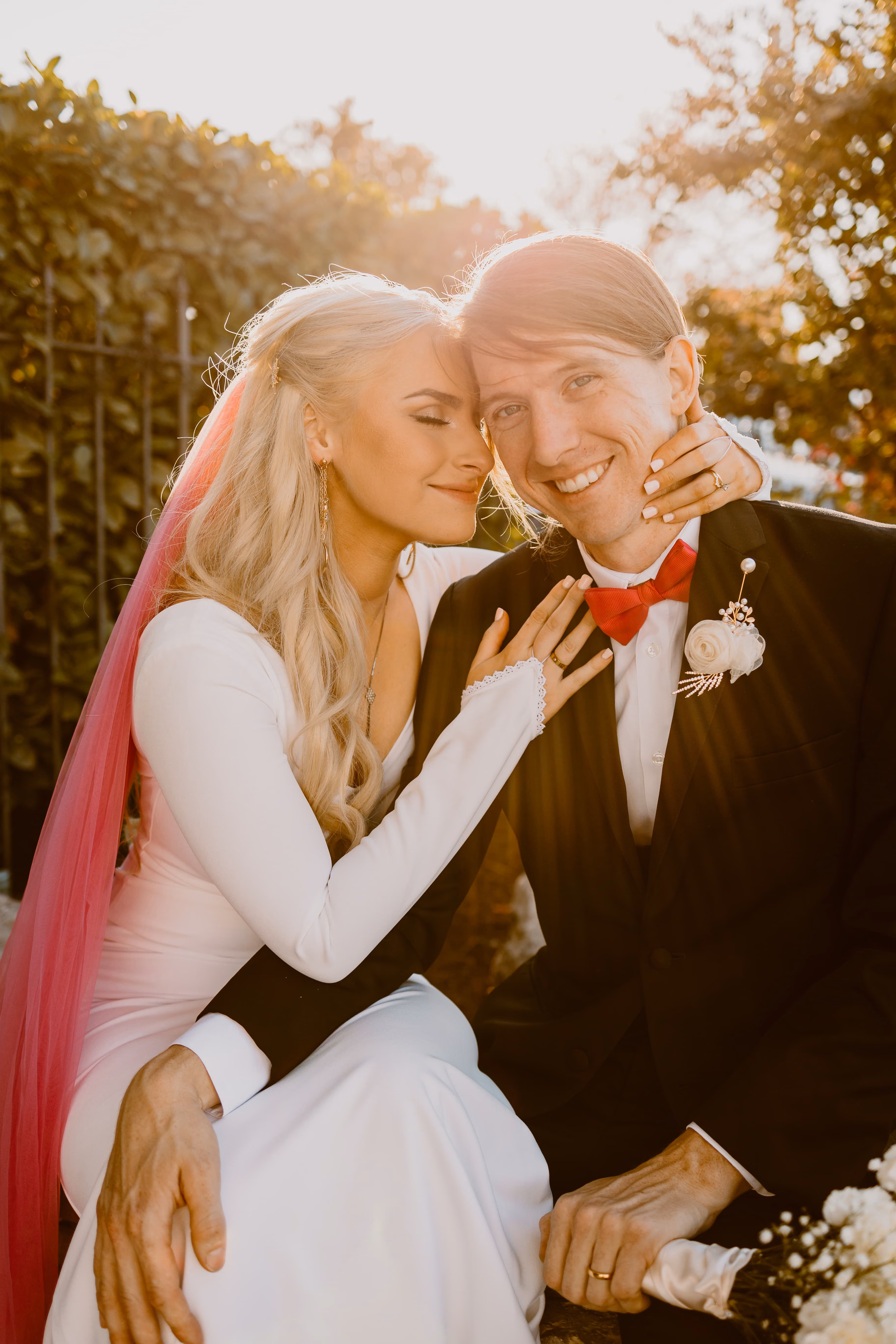 Bride and groom laughing together in golden evening light