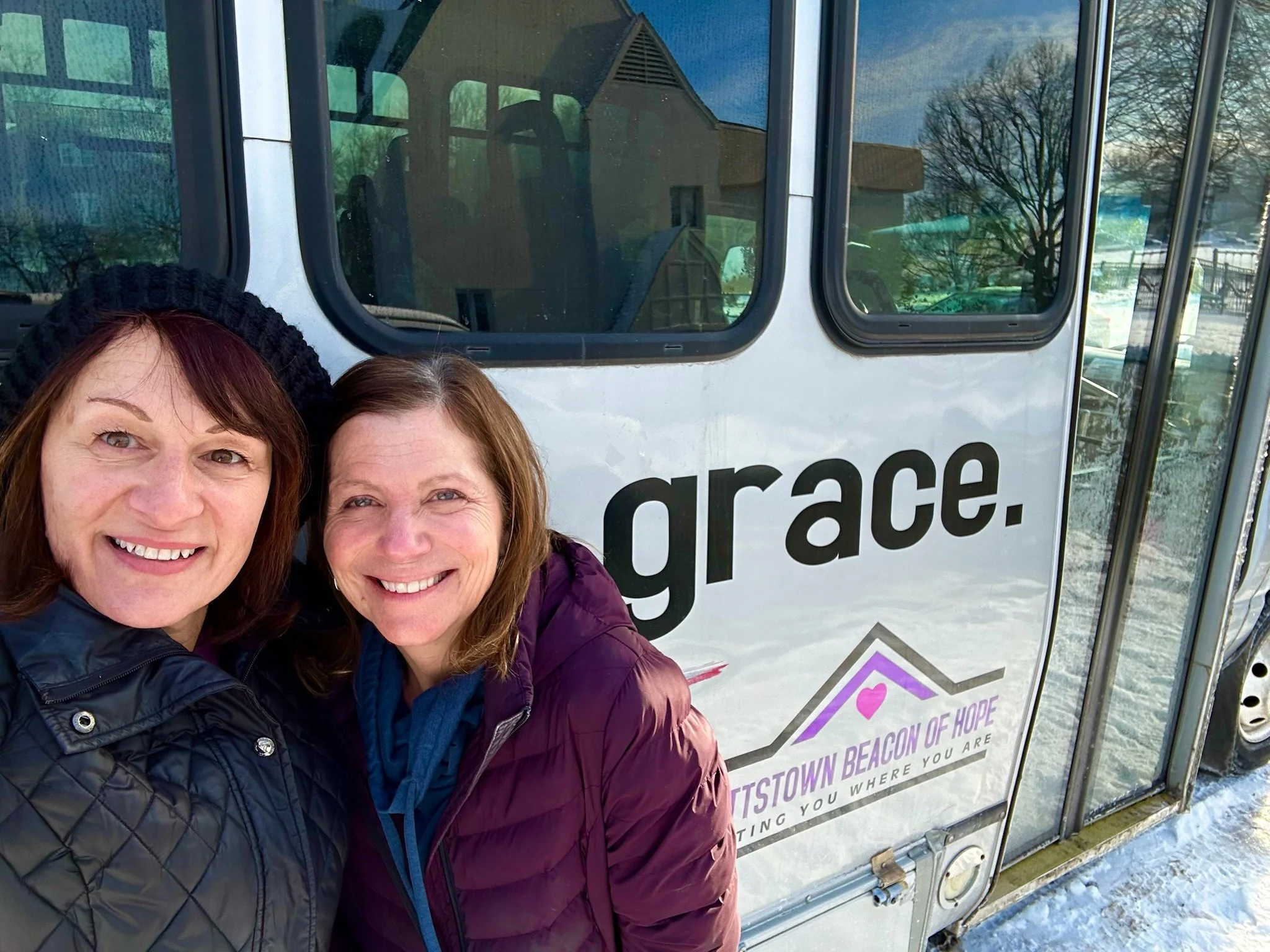 People embracing in colorful jackets
