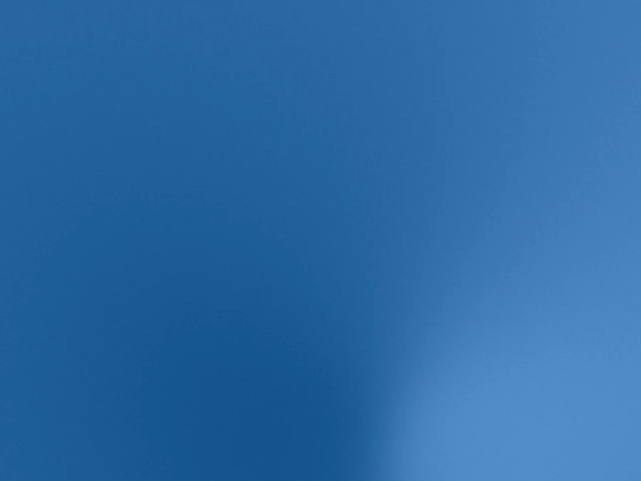 Smooth blue gradient background transitioning from darker to lighter blue.