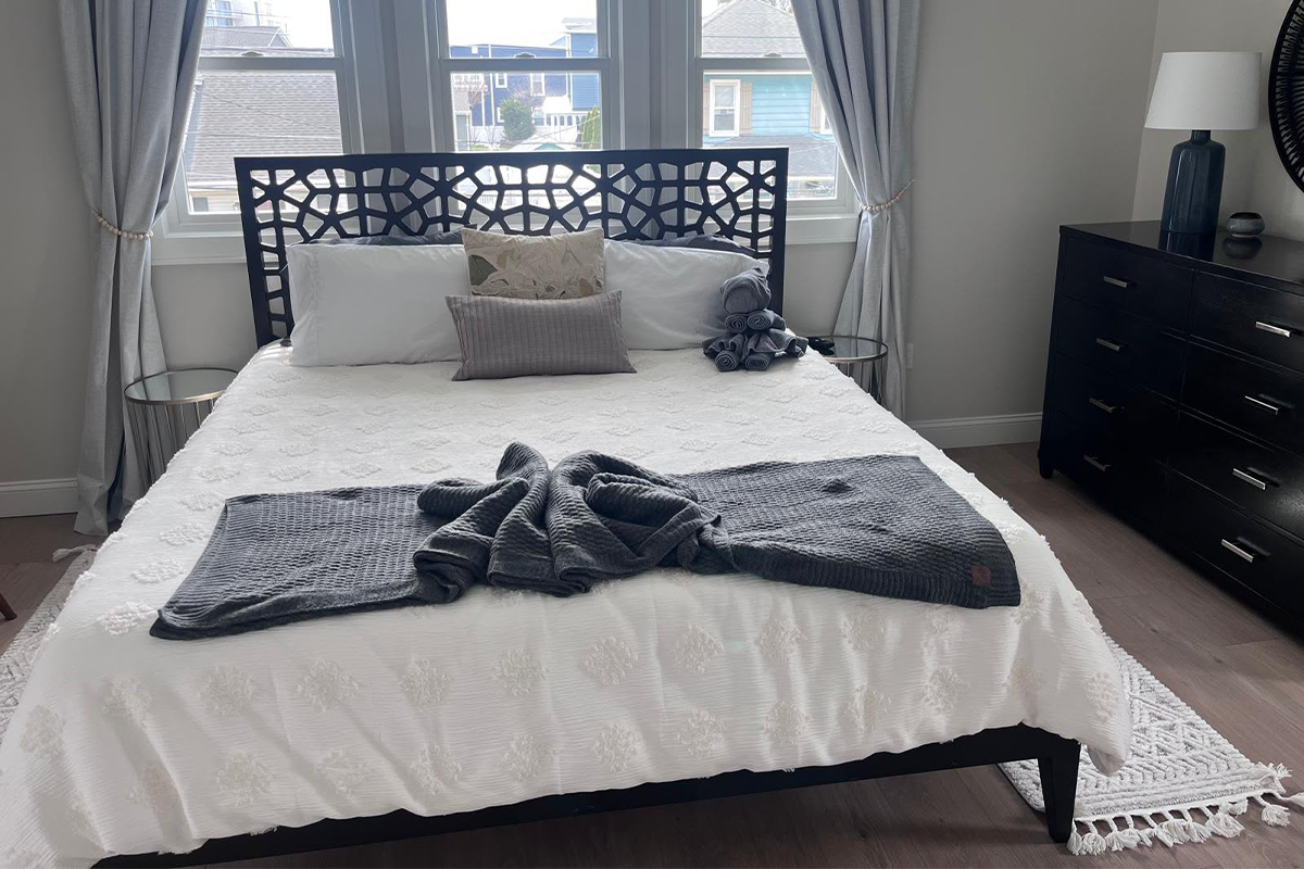 A bed Neatly made and detailed by Genesis Cleaning services
