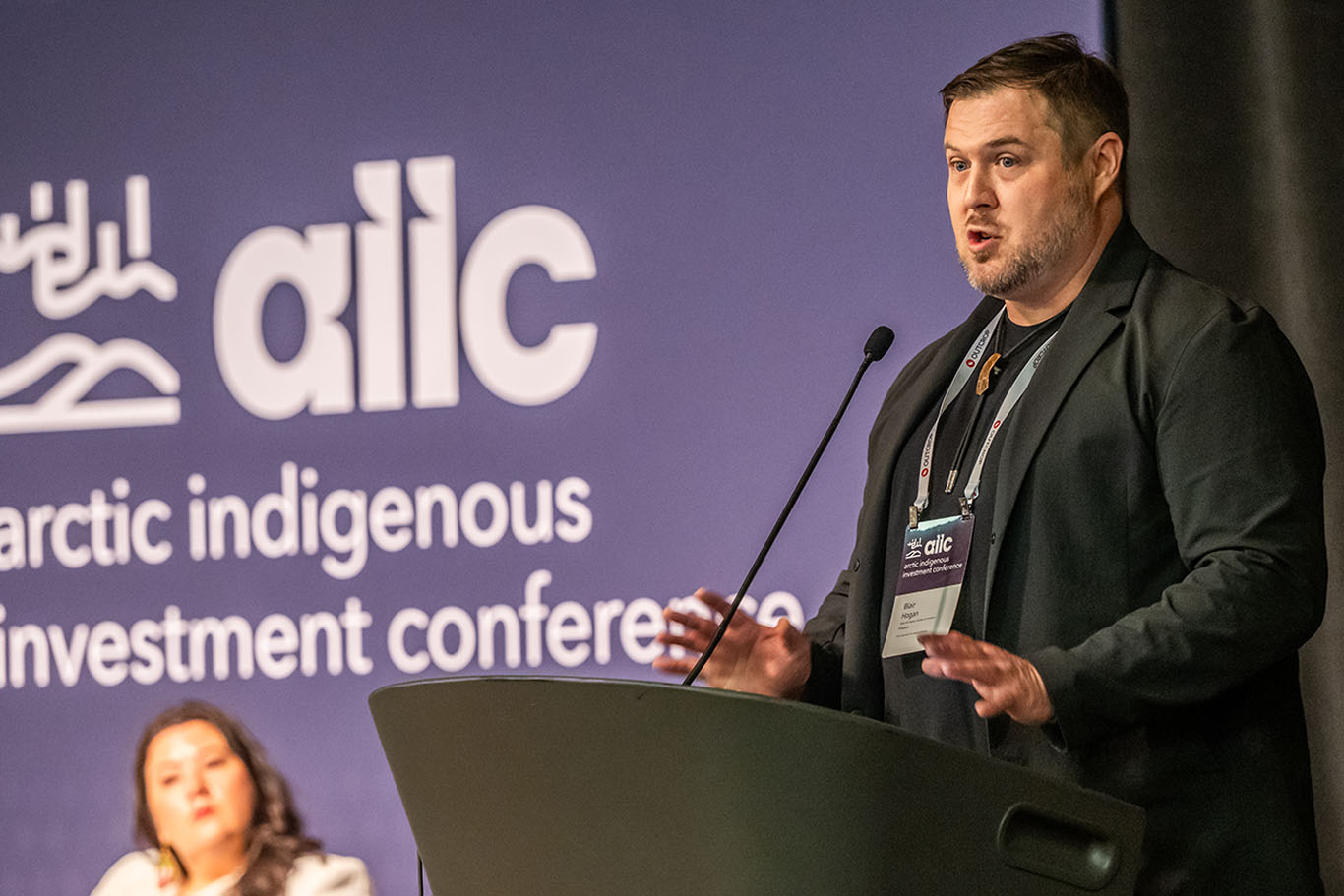 Speaker at the podium during the Arctic Indigenous Investment Conference.