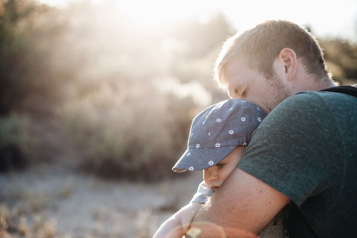 A veteran father embracing his daughter.