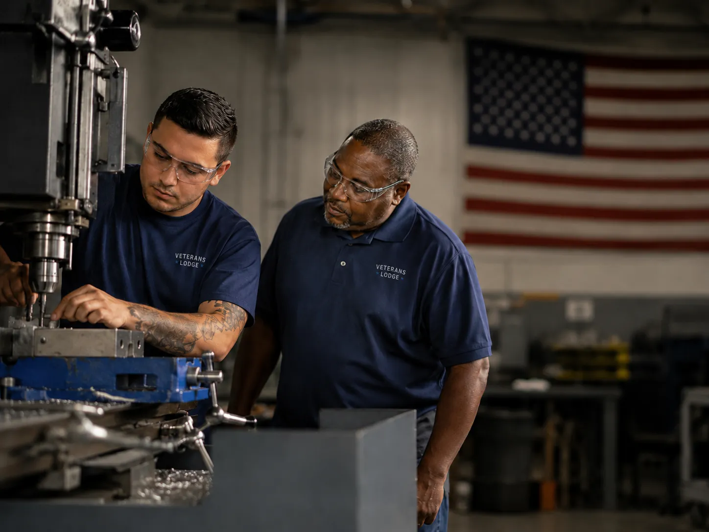 A veteran learning machining under a mentor's guidance in a workshop.