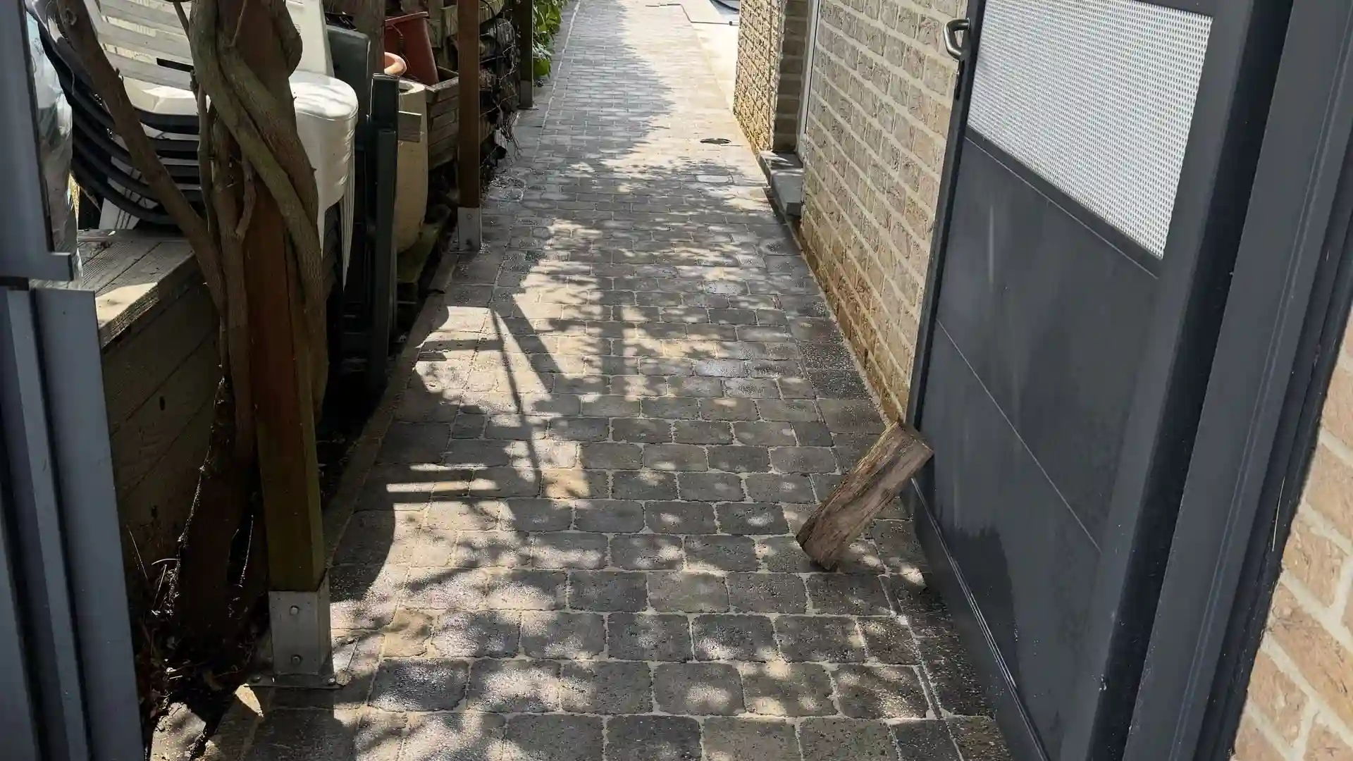 Passage en pavés le long d'une maison, après nettoyage