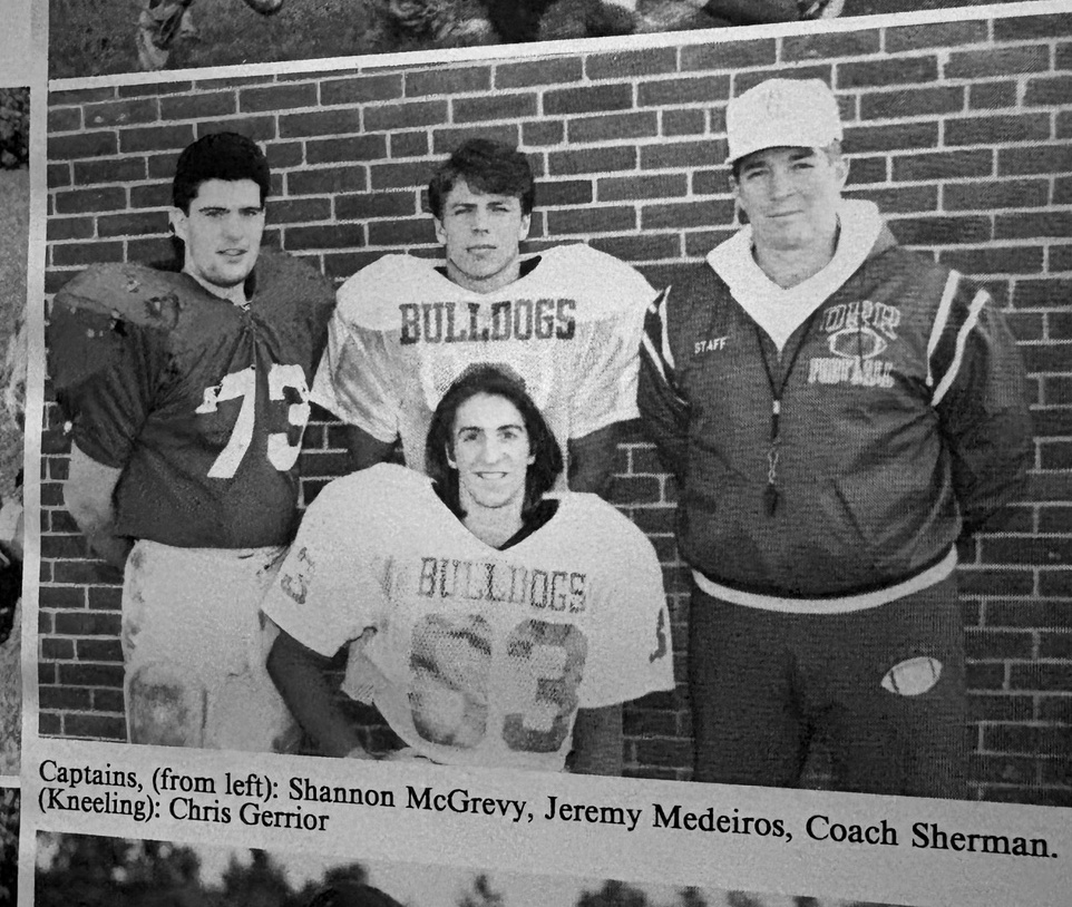 Old Rochester Regional football captains pictured with Coach Craig Sherman in a yearbook photograph