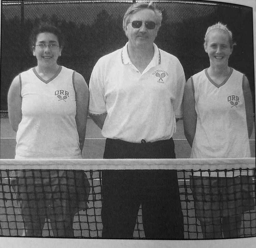 Bob Hohne standing between two ORR girls tennis players in a yearbook photograph