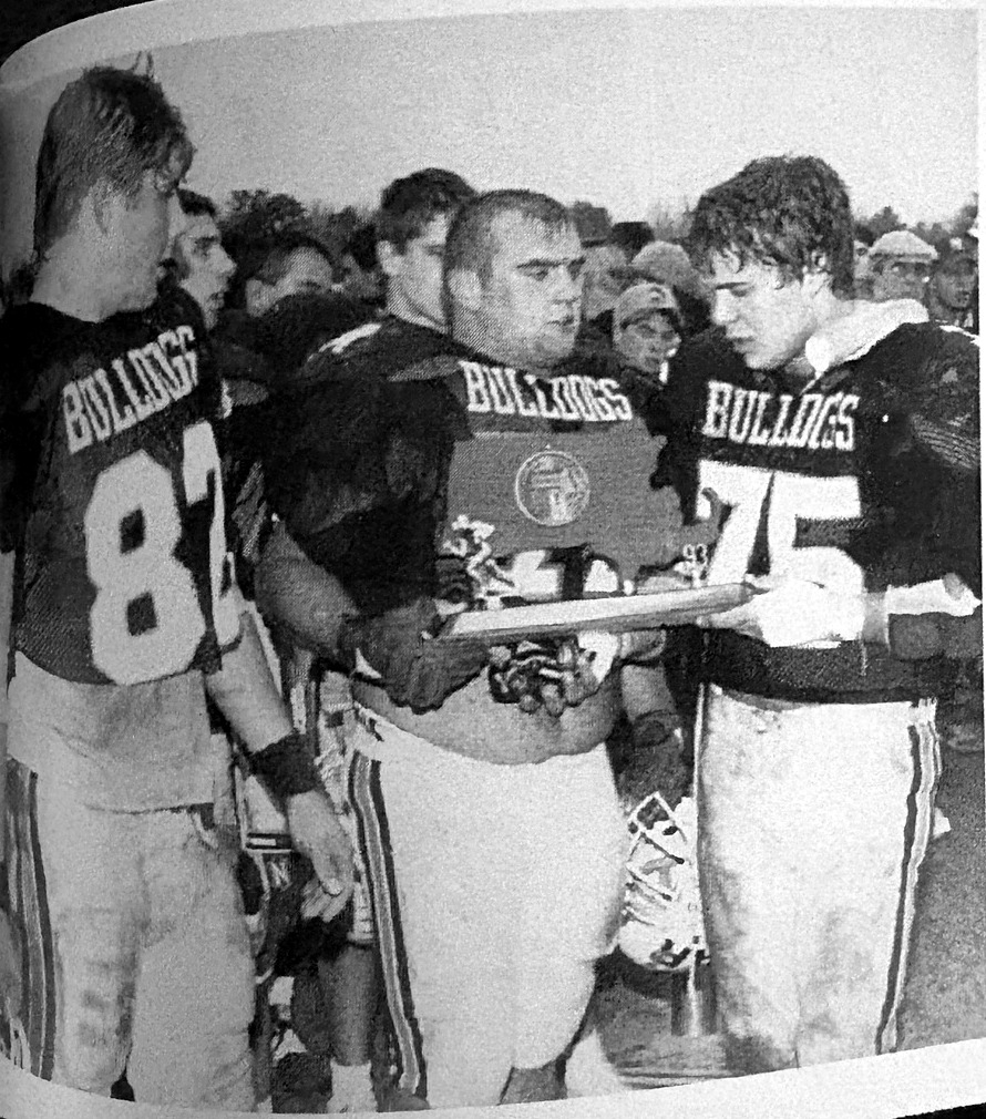 Scott Dragos, number 75 at right, holding an award with Old Rochester Regional football teammates