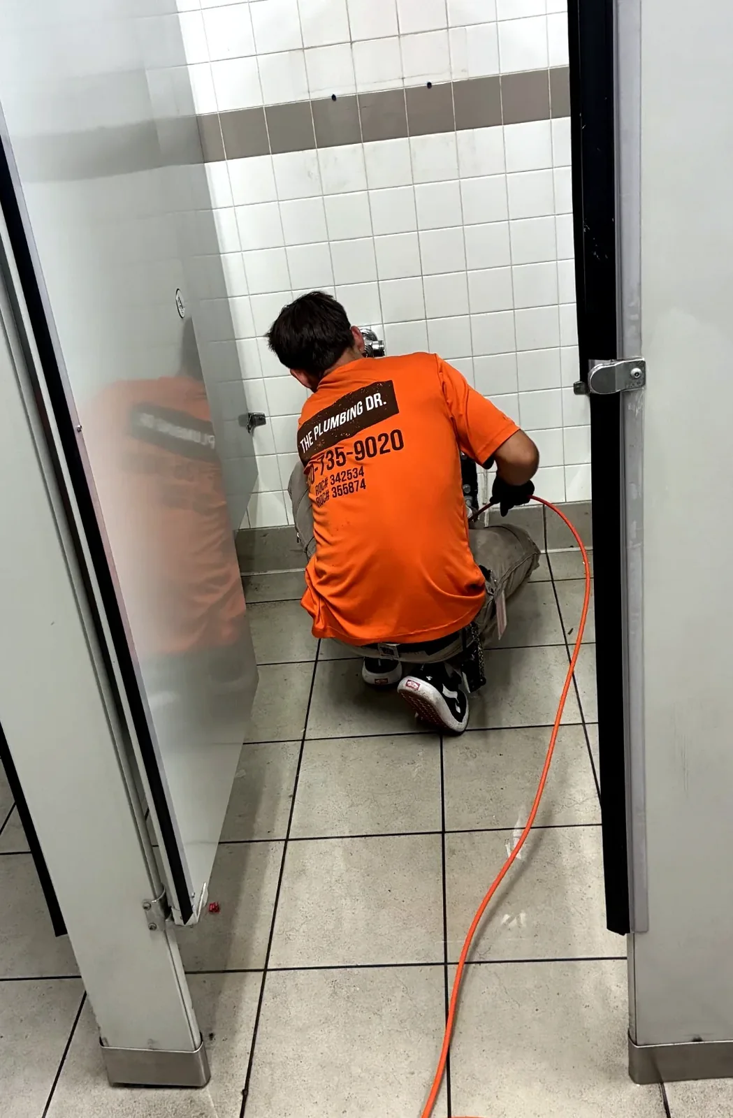 The Plumbing Dr. technician snaking a commercial drain line in Mesa, AZ