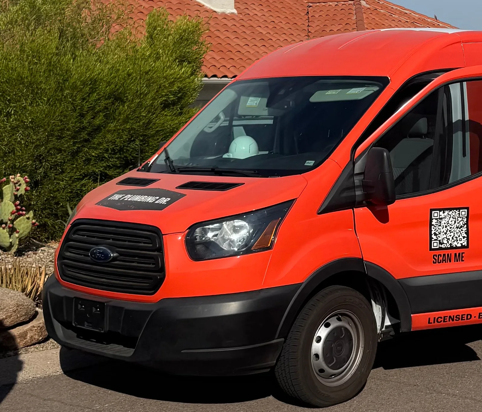 The Plumbing Dr. service van parked at a home in Mesa, AZ