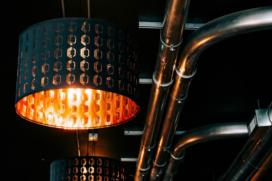 Copper pipework beside a warm pendant light.