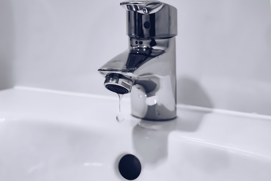 Chrome faucet dripping into a white basin.