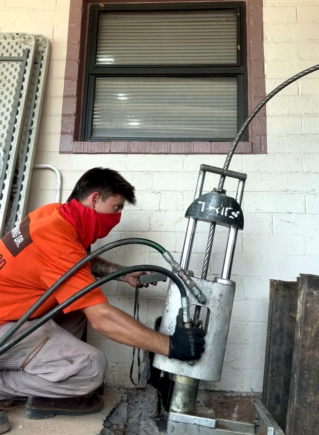 The Plumbing Dr. technician operating pipe repair equipment at a Mesa, AZ property