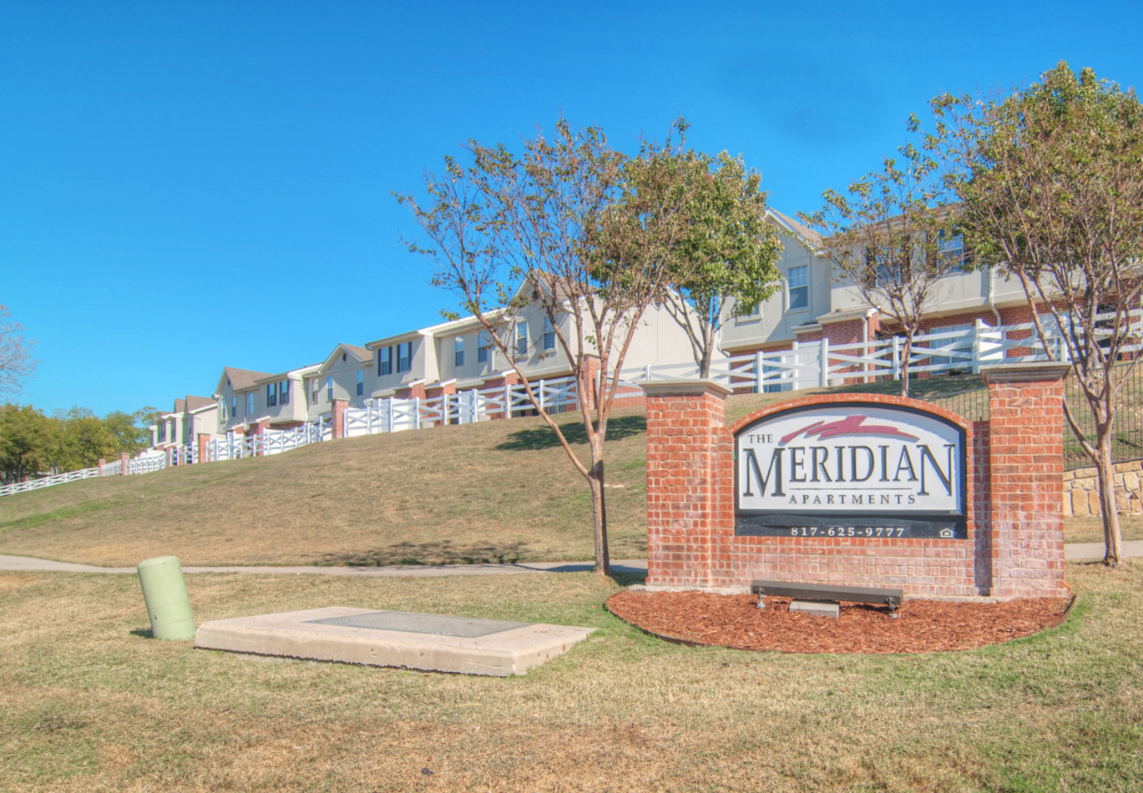 Exterior of apartments with The Meridian monument sign