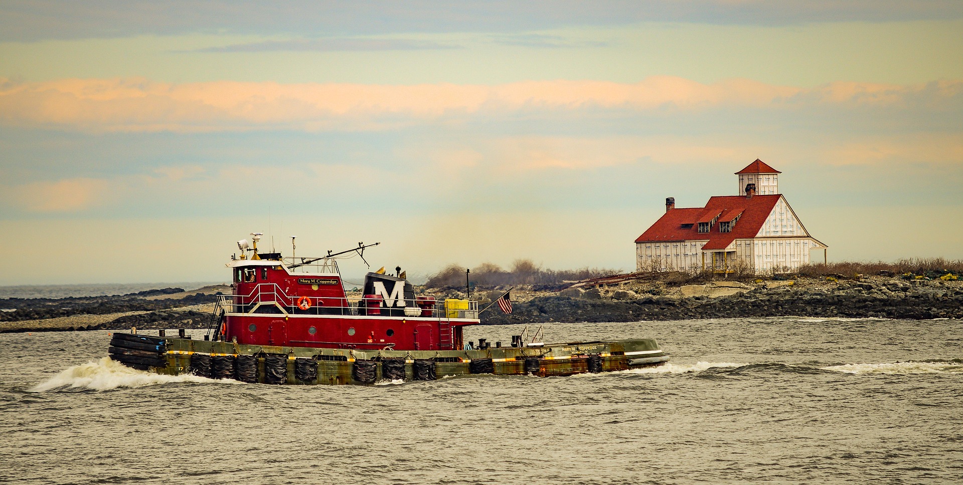 A tugboat under way in a working harbour