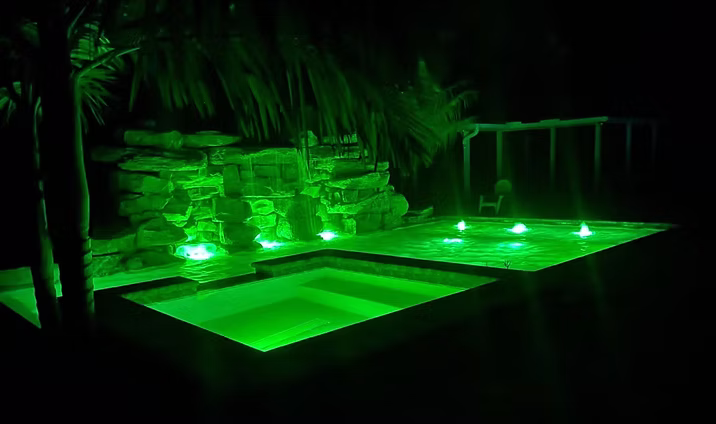 Landscape lighting around a pool at night