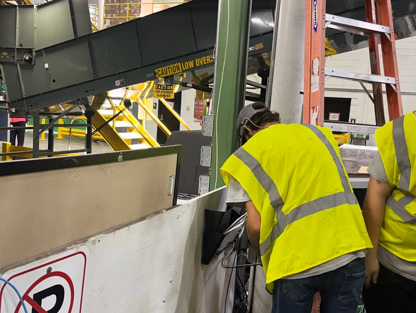 Electricians completing a commercial electrical installation.