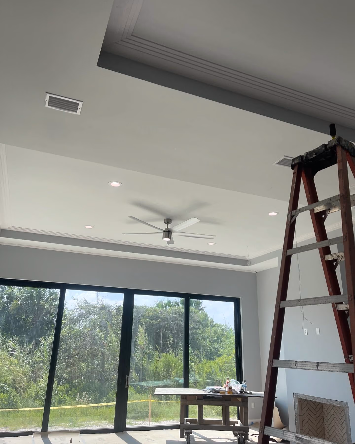 Finished living room with recessed lighting and an installed ceiling fan.