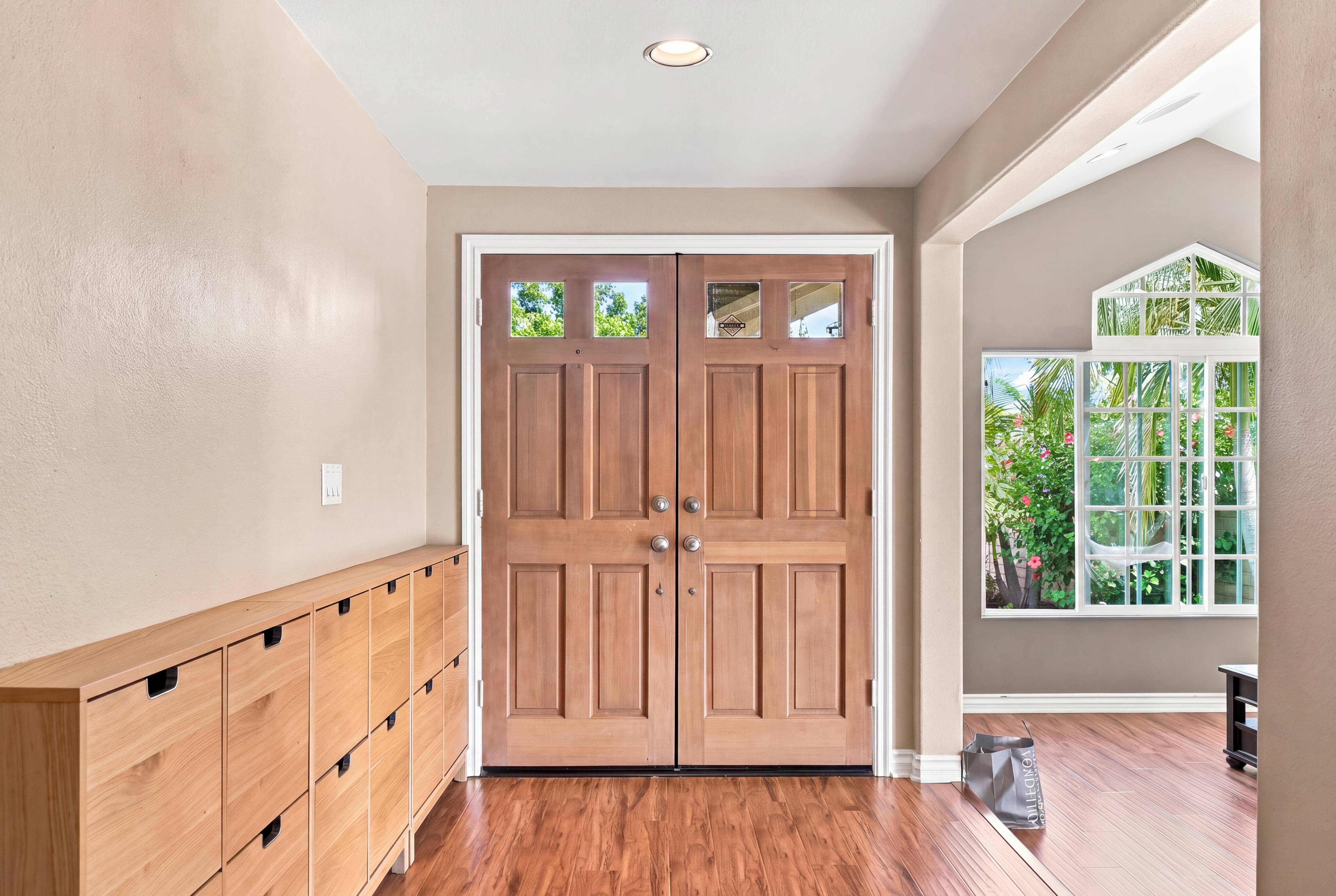 Entry foyer with double wood front doors, built-in cabinetry and hardwood floors, Anaheim rental