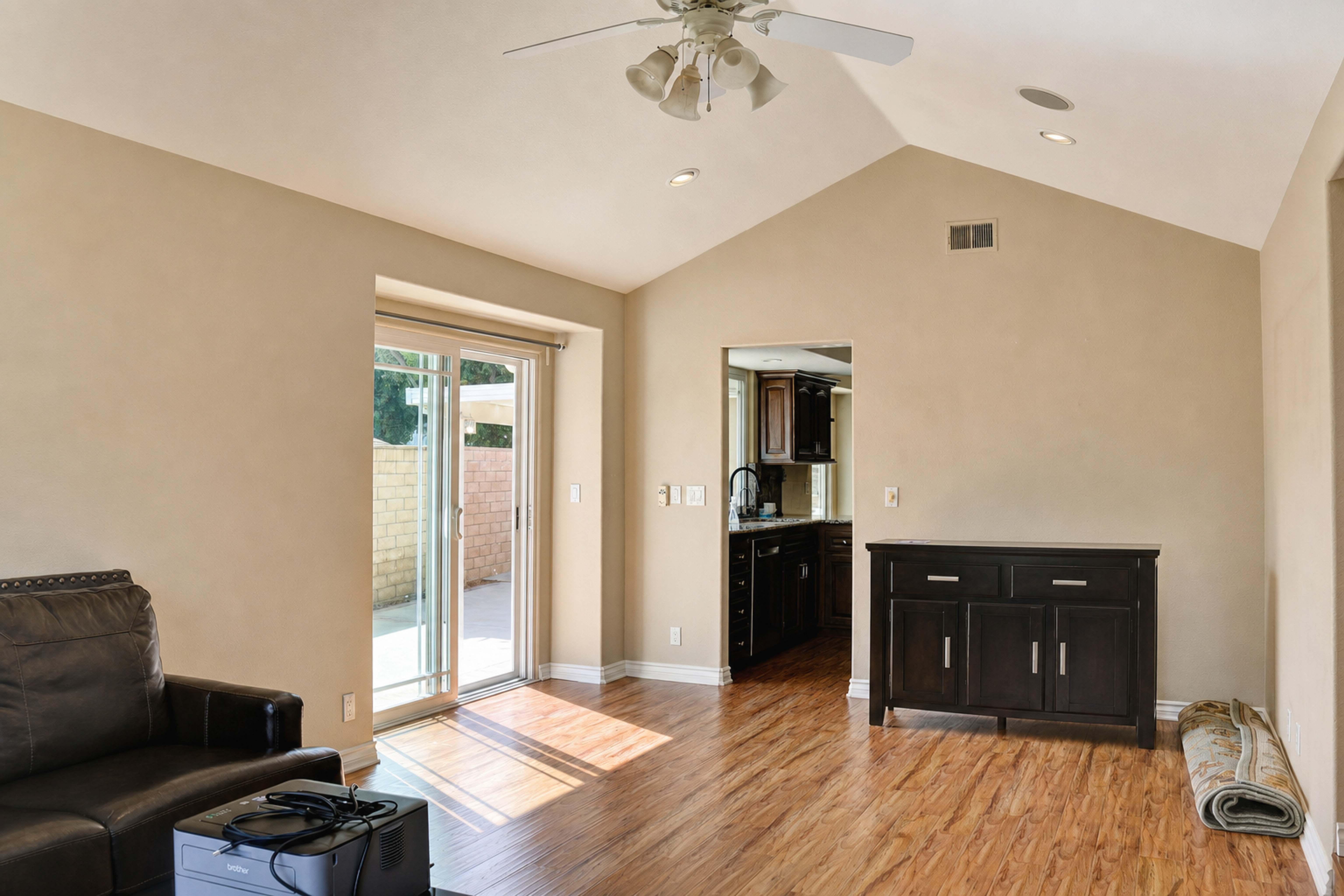 Family room with sliding glass door to the patio and hardwood floors, Anaheim vacation rental