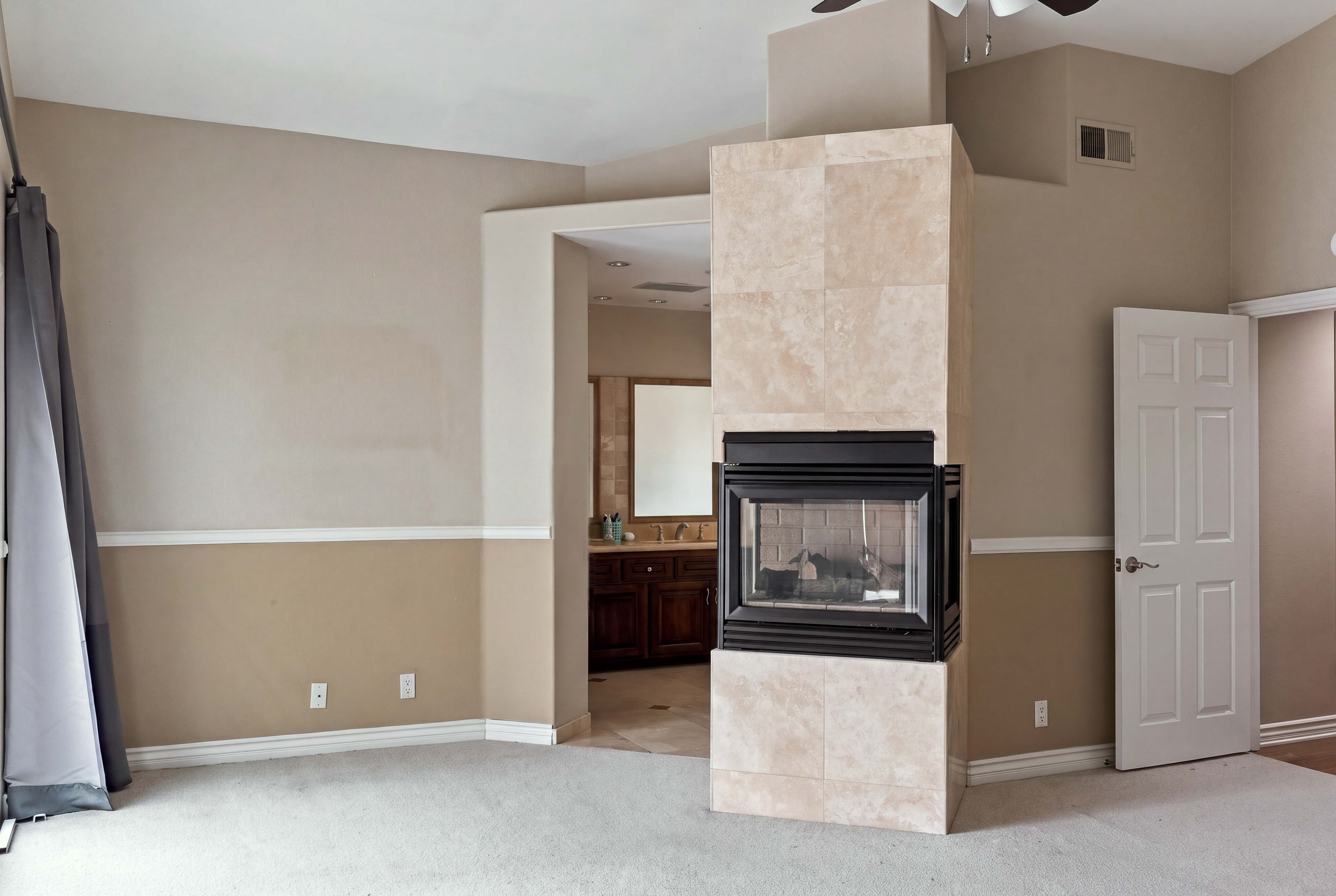 Family room with floor-to-ceiling tiled fireplace open to the kitchen, Anaheim rental