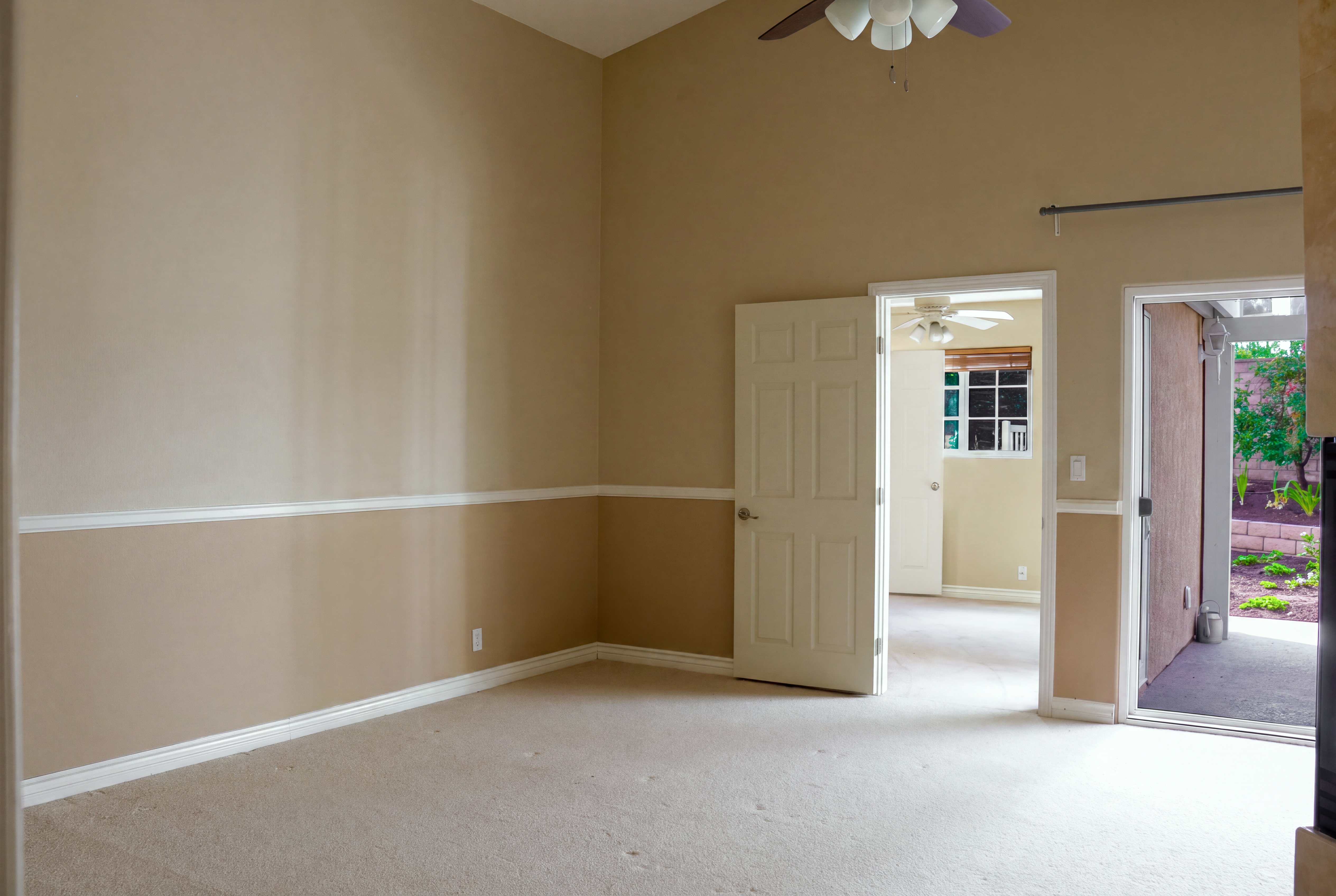 Unfurnished room with chair rail and doorway to the yard, Anaheim rental home interior