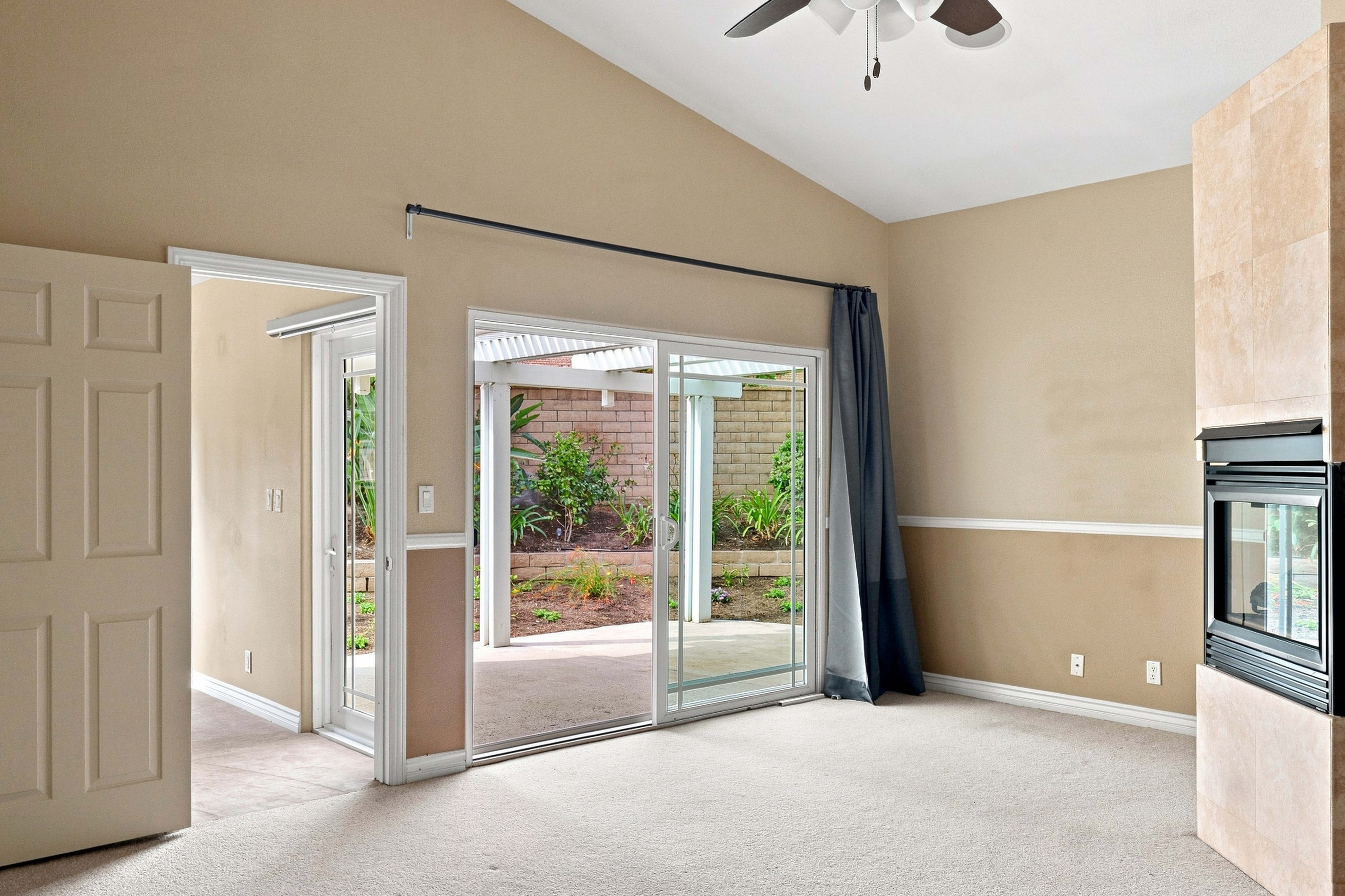 Carpeted bonus room with sliding door to the back patio, Anaheim short-term rental