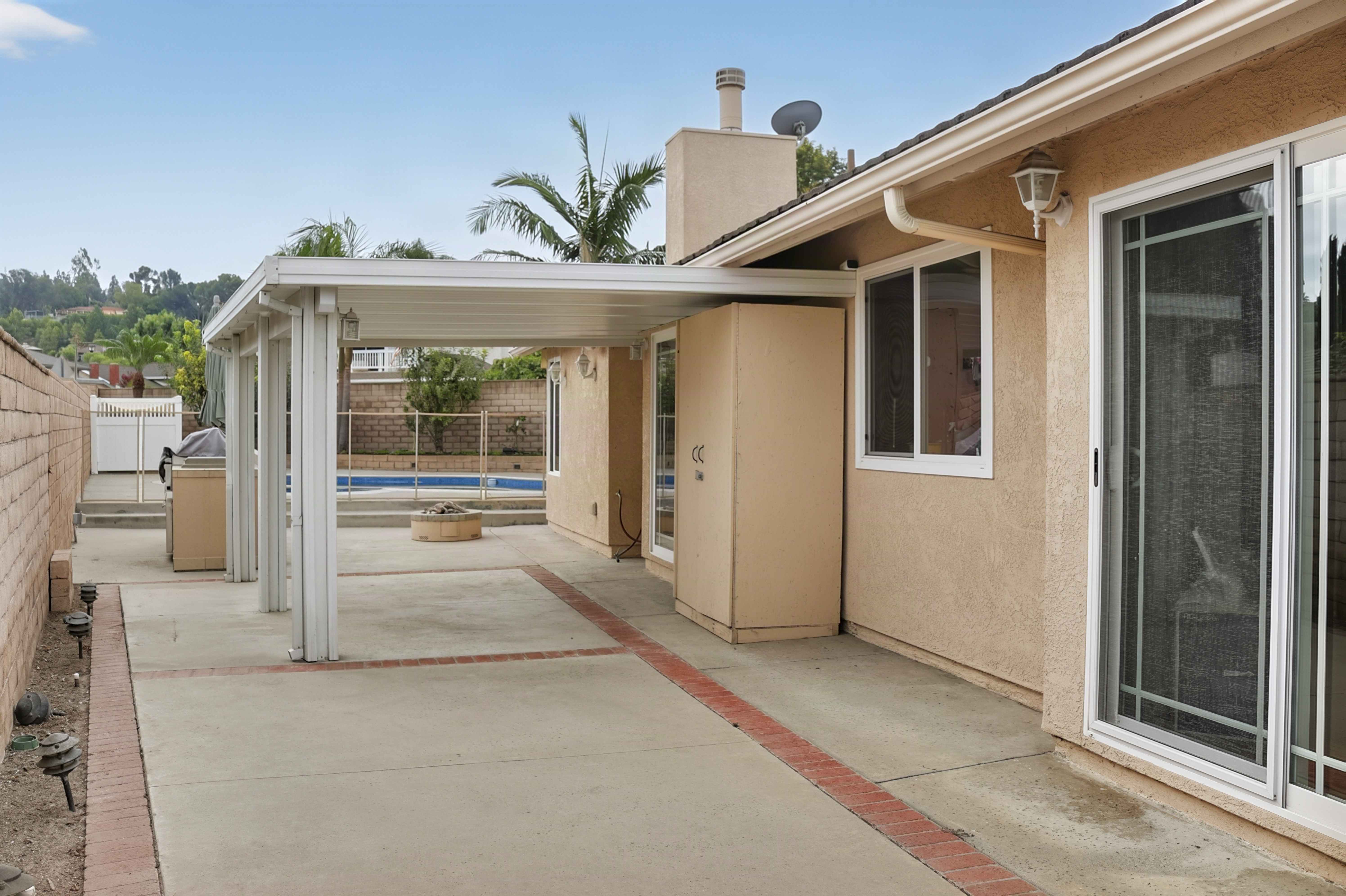 Side patio with pergola and sliding doors to the house, Anaheim short-term rental
