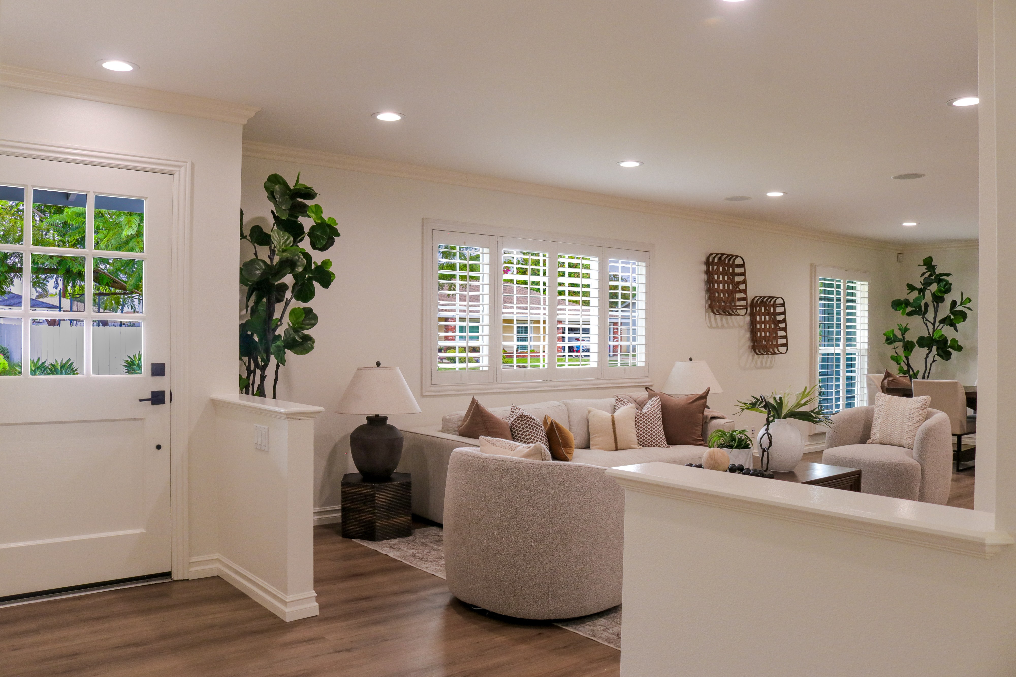 Living room with French doors, greenery and soft neutral furnishings, Tustin residential listing