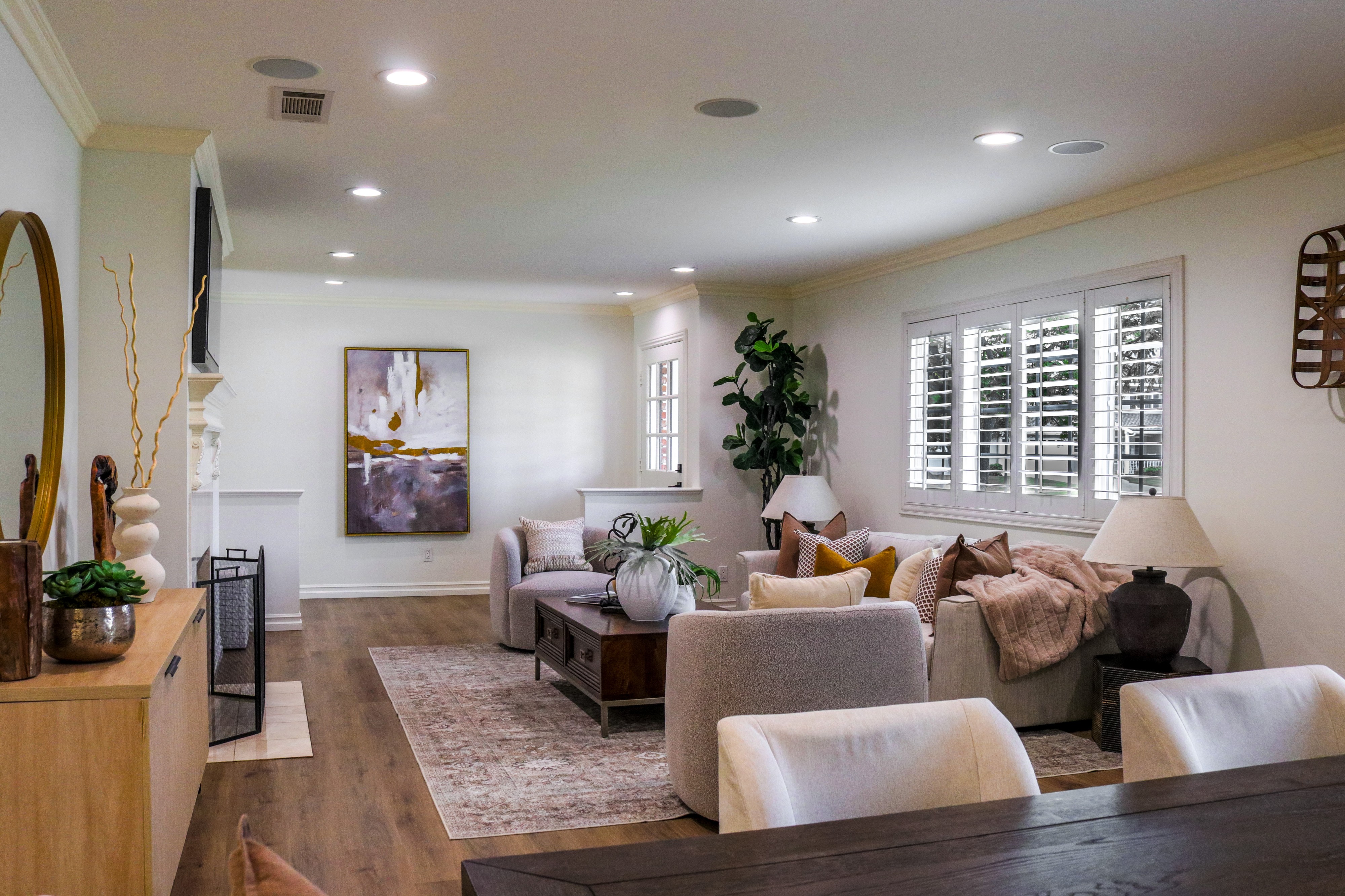 Open living room with plantation shutters, area rug and paired sofas, Tustin home for sale
