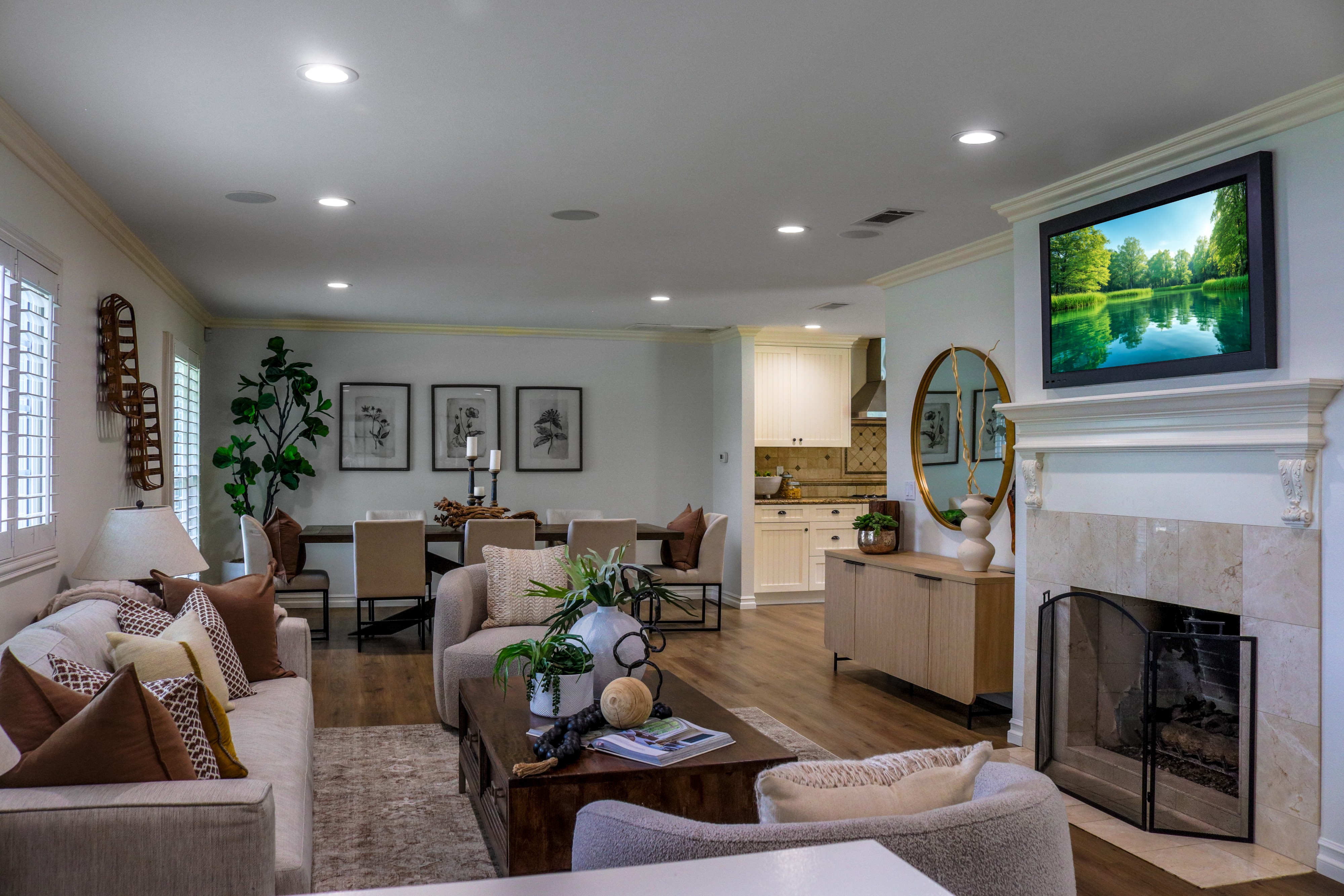 Staged living room with fireplace, mounted television and sectional seating, Tustin listing