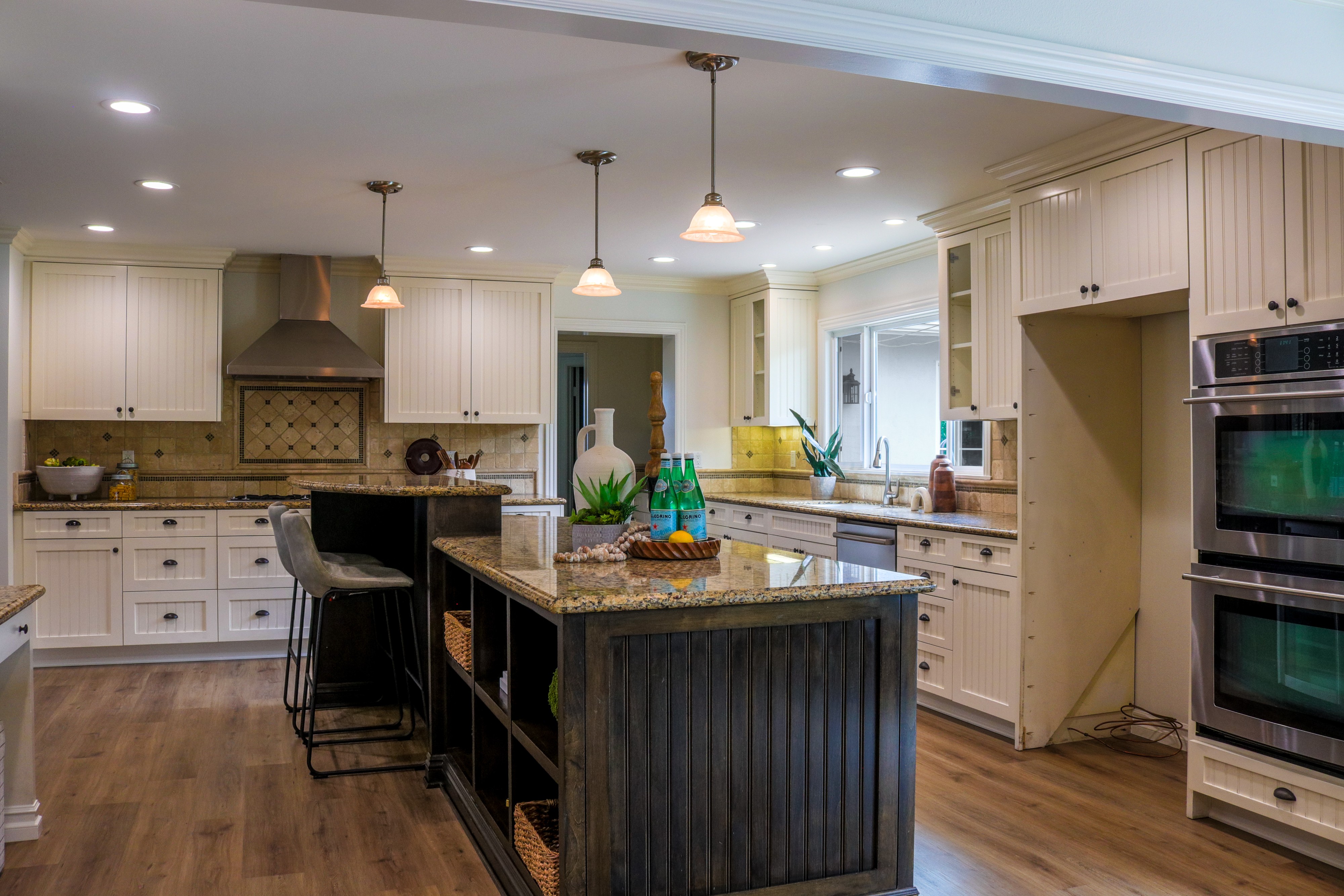 Kitchen with double wall ovens, large island and range hood, Tustin residential listing