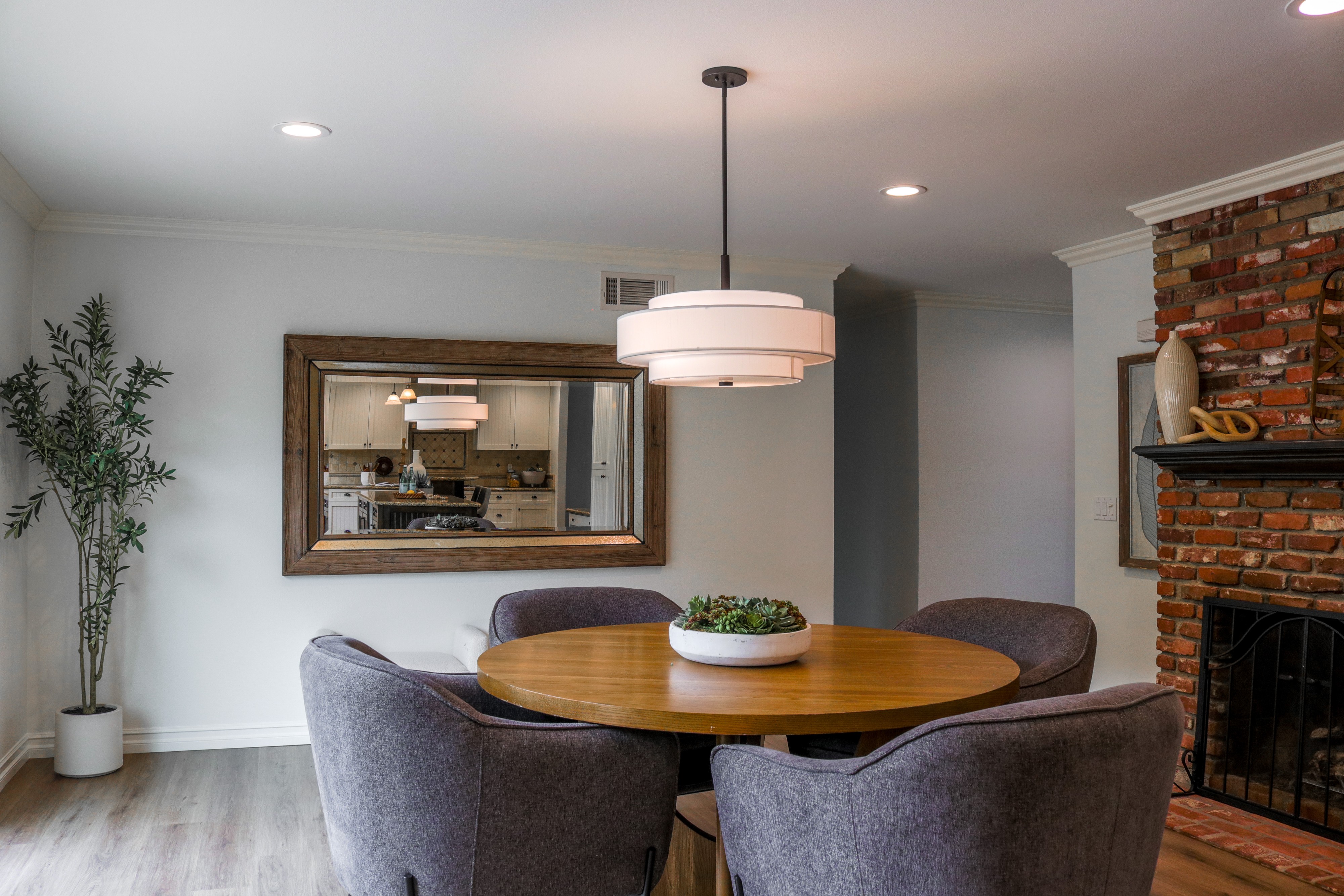 Dining nook with round table, drum pendant and framed mirror, Tustin home for sale